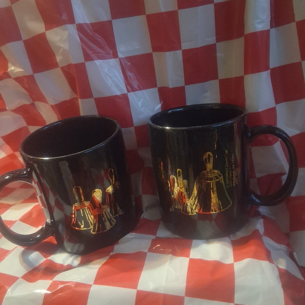 2 VINTAGE BLACK WITH GILDED 22K GOLD BELLS DESIGN MUGS.